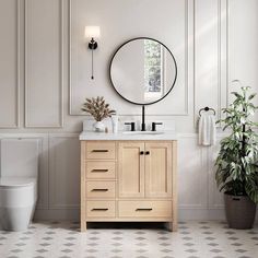 a white toilet sitting next to a wooden vanity in a bathroom under a round mirror