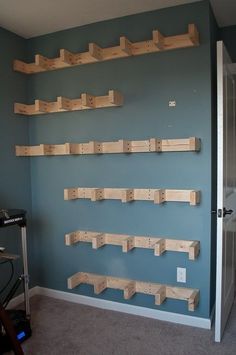 a room with several wooden shelves on the wall