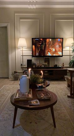 a living room filled with furniture and a flat screen tv mounted to the side of a wall