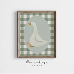 a white duck sitting on top of a green and white checkered tablecloth covered wall