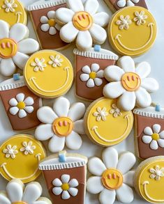 decorated cookies with smiley faces and flowers on them