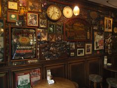 there are many clocks on the wall in this restaurant