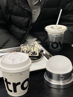 a person sitting at a table with some food and drinks