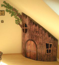 a room with a tree house painted on the wall