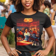 Step back in time with Sweet Joy's Soul Food Diner Tee Shirt, where classic charm meets modern comfort. Crafted for those who appreciate the nostalgia of a 50s-style diner and celebrate the rich culture of African American soul food.   The Sweet Joys Soul Food Diner Tee Shirt features an illustration of a retro 50s style diner with an African American woman waitress. This vintage style illustration showcases the working girl in a dining setting, evoking the era's unique charm, when diners were t Retro Short Sleeve Tops For Retro-themed Events, Fitted Vintage T-shirt With Retro Print, Vintage Tops With Graphic Print For Retro-themed Events, Dining Setting, Culture Club, 50s Style, American Woman, African American Women, 50s Fashion