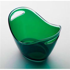 a green glass bowl sitting on top of a table