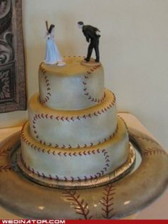 a baseball themed wedding cake with a bride and groom on top