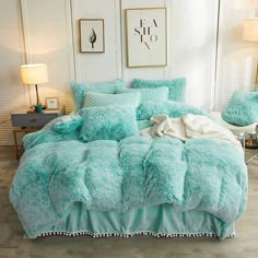 a bed with blue comforters and pillows in a room