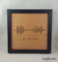 a wooden frame with a sound wave in black and brown on the inside, it says do and do too