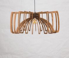 a wooden light fixture hanging from a ceiling