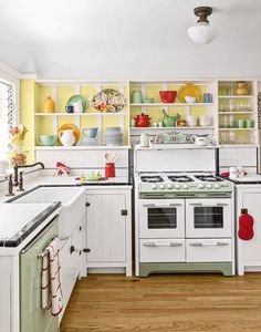 a white stove top oven sitting inside of a kitchen