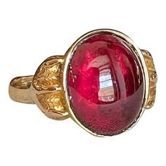 Step back to a time of refined elegance with this Victorian Garnet Signet Ring, a splendid piece that exudes the charm of the early 19th century. This impressive ring features a large cabochon garnet, measuring 14.4x11.5 mm, set in a distinctive signet style. The garnet is closed backed, emphasizing its rich, deep color and classic appeal.  Originally crafted around 1840-50, the ring has been expertly re-shanked; while the top mounting and the intricately detailed clawed feet are made of 15 karat gold, the band itself has been updated with 9 karat gold. Measuring 15.3 mm north to south and 19.3 mm across at the face, the ring sits 6 mm off the finger and narrows to 2.5 mm at the back. Weighing 4.8 grams and sized at 10, this well-loved ring showcases both historical craftsmanship and a tim Luxury Ruby Ring With Cabochon Cut, Vintage Garnet Jewelry, Formal Cabochon Ruby Ring, Luxury Ruby Oval Cabochon Ring, Luxury Ruby Ring Oval Cabochon, Heirloom Red Ruby Cabochon Ring, Elegant Red Dome Ring For Formal Occasions, Heirloom Red Cabochon Ruby Ring, Luxury Ruby Ring With Oval Cabochon