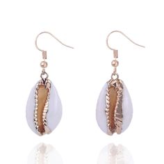 PRICES MAY VARY. *Lovely plated cowrie shells! They are natural, so each piece is unique. The golden color makes them more elegant and modern, while at the same time embracing the ocean's nature, dangling gracefully by your ears and shimmering as you move. *A perfect complement to any outfit, whether you're dressing up for a formal occasion or adding a touch of bohemian charm to your everyday look. *With the hooks, they are easy and comfortable to wear, allowing you to showcase your personal sty Cowrie Shell Earrings, Beach Jewelry Boho, Cowrie Shells, Beach Boho, Cowrie Shell, Shell Earrings, Boho Beach, Golden Color, Jewelry Pouch