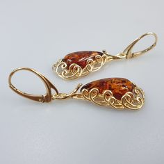 Big hanging Amber earrings. Made off Gold plated sterling silver 925 (Gold colour). With silver hallmarks. Big brown cognac Amber. Very cute and elegant. Each pair amber stone color ia slightly different due to an amber is real gemstone.  Lever back closure. Length 5 cm. Width 1,2 cm. Weight 6,3 gr.  This item was made of natural Baltic Amber. All the amber used in my jewelry is collected in my home country Lithuania.  I sell only genuine,  real, not pressed, authentic, natural Baltic Amber. Ite Pear-shaped Pierced Earrings For Gift, Pear-shaped Earrings For Gifts, Amber Teardrop Pierced Jewelry, Drop Earrings As A Gift, Teardrop Hallmarked Hoop Earrings As Gift, Hallmarked Teardrop Hoop Earrings As Gift, Gold Pear-shaped Teardrop Earrings In Sterling Silver, Amber Dangle Earrings For Anniversary, Amber Drop Earrings With Ear Wire