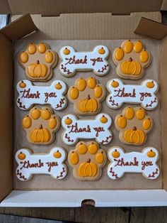 decorated cookies in a box with thank you written on the top and dog paws