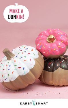 three decorative pumpkins with frosting and sprinkles