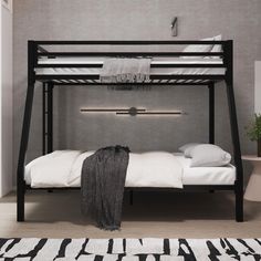 a black bunk bed with white sheets and pillows