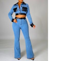 a woman in blue jeans is posing for the camera with her hands on her hips