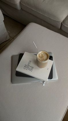 a cupcake sitting on top of a white tray next to a book and remote control