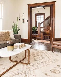 a living room filled with furniture and a rug