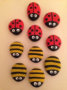 six ladybug magnets with eyes and stripes are arranged on a white surface