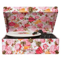 an old fashion record player with flowers on it's cover and its case is open