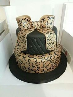 a leopard print cake with a bow on top