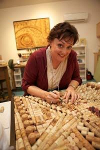 a woman standing over a table filled with breads and crackers on top of it