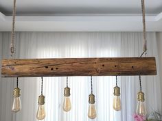 some light bulbs hanging from a wooden beam