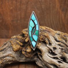 Vintage sterling silver inlaid turquoise ring. The ring is 2 1/8" long x 5/8" wide. Some of the turquoise has changed color over the years. Natural turquoise will do this when it is in contact with skin oil or chemicals. The ring is size 9. It looks like the work of Zuni Amy Quandelacy or Wesley but is not signed. The ring is in good condition. Thank you for shopping in our store. Please let us know if you have questions. RING-1798K-MS-7 k *The color you see on your screen may not reflect the ac Southwestern Style Turquoise Inlay Ring, Skin Oil, Tucson Az, Oils For Skin, Natural Turquoise, Tucson, Rings Statement, Vintage Sterling Silver, Turquoise Ring