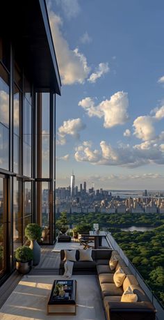 an outdoor living area with couches, tables and large windows overlooking the cityscape