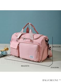 a pink duffel bag sitting on top of a table next to a pair of shoes