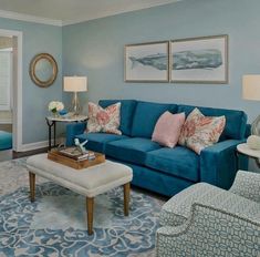 a living room filled with blue furniture and decor