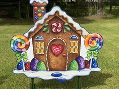 a gingerbread house with candy and lollipops painted on it's side