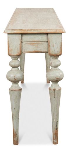 an old white wooden table with turned legs