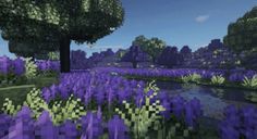 purple flowers and trees in the middle of a field