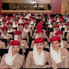 some women in red hats are sitting down