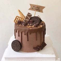 a birthday cake with chocolate and cookies on top