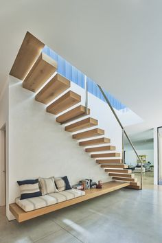 a living room filled with furniture under a stair case