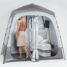 a man standing in front of a portable shower