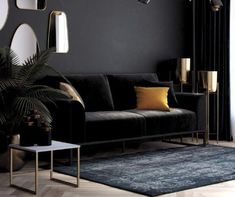 a living room with black walls and gold accents on the furniture, rugs and mirrors