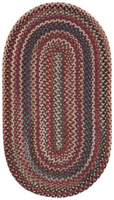 the oval rug is made with multicolored braiding