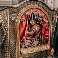 a man and woman standing next to each other in front of a horse drawn carriage