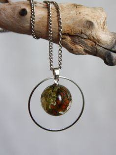 "A magnificent pendant made of real gifts of nature: moss, lichen, hazel cone in pure epoxy resin. The metal headband adds charm and emphasizes the beauty of the sphere. But you can get a pendant without a ring. Comes with a 45cm (18 \") silver plated chain. If you need a long metal chain, please indicate it in your message. I will gladly do it for you! A great gift for yourself or an important person! All jewelry comes in a box and is ready for a gift! When you are going to swim in the pool or Round Amber Resin Jewelry, Nature-inspired Resin Round Pendant Jewelry, Green Pressed Flower Round Pendant Jewelry, Nature-inspired Round Resin Pendant Jewelry, Green Pressed Flowers Round Pendant Jewelry, Nature-inspired Jewelry For Healing With Natural Inclusions, Nature-inspired Jewelry With Natural Inclusions In Round Pendant, Nature-inspired Moss Agate Jewelry With Natural Inclusions, Nature-inspired Silver Resin Jewelry