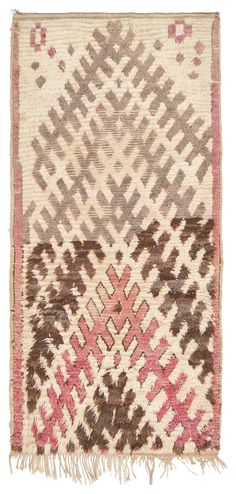 an old rug with pink, brown and white designs on the bottom half of it