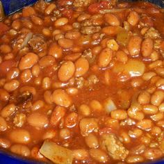 a blue bowl filled with beans and meat