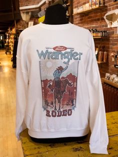 These T's and Sweatshirts are the perfect way to profess your love for all things Western! Fuck Around And Find Out, Wrangler, Queen Dolly and Cowboy Take Me Away are 50% Cotton and 50% Polyester Backwoods Barbie, Retro Dolly, Willie Nelson shirts are 100% Cotton Black Dolly Sweatshirt is 90% Cotton, 10% Polyester Cute Western Tops, Dolly Sweatshirt, Western Shopping, Edgy Cowgirl, Western Closet, Willie Nelson Shirt, Western Shirts For Women, Roma Style, Backwoods Barbie