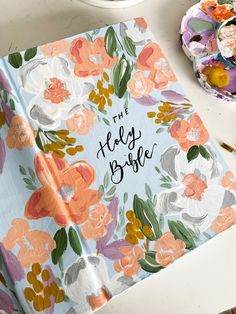 an open book with the words, the holly bride on it next to some flowers