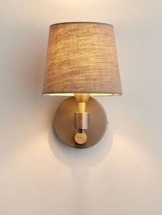 a wall light with a shade on it