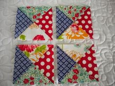 four patchwork squares are arranged on a quilt